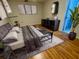 A cozy bedroom with wood laminate flooring, contemporary decor, and a mounted flatscreen TV at 1219 Serissa Ct, Orlando, FL 32818