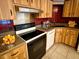 Kitchen featuring light wood cabinetry, an electric cooktop, and black appliances at 1219 Serissa Ct, Orlando, FL 32818