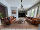 Bright living room with stylish furnishings, including leather sofas, accent tables, and large windows for natural light at 1219 Serissa Ct, Orlando, FL 32818
