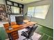Home office featuring a large wooden desk, ergonomic chair, and shelving, creating a functional workspace at 1219 Serissa Ct, Orlando, FL 32818