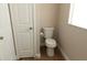 Modern toilet in neutral bathroom with updated fixtures and wooden flooring at 1220 Zapata Pl, Lady Lake, FL 32159