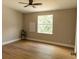 Bedroom featuring hardwood floors, neutral walls, and a window letting in natural light at 1220 Zapata Pl, Lady Lake, FL 32159