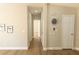 Hallway with wood-look floors and neutral paint and doors at 1220 Zapata Pl, Lady Lake, FL 32159