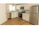Modern kitchen featuring stainless steel appliances, white cabinets, and marble countertops at 1220 Zapata Pl, Lady Lake, FL 32159
