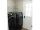 Laundry room featuring side-by-side washer and dryer with adjacent exterior door at 1220 Zapata Pl, Lady Lake, FL 32159