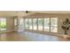 Bright and airy living room with large windows and light wood flooring at 1220 Zapata Pl, Lady Lake, FL 32159