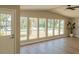 Bright living room featuring multiple windows, a ceiling fan, and wood-look floors at 1220 Zapata Pl, Lady Lake, FL 32159