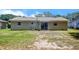 Rear view of home showing a spacious backyard with sliding glass doors leading to the patio at 14 Cyclops Dr, Apopka, FL 32703