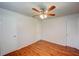 Spacious bedroom with wood-look floors, a ceiling fan, two closets, and natural lighting at 14 Cyclops Dr, Apopka, FL 32703