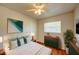 Comfortable bedroom with neutral colors, a ceiling fan, dresser, and plenty of natural light at 14 Cyclops Dr, Apopka, FL 32703