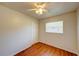 Compact bedroom with wood-look floors, a white ceiling fan, a closet and a window at 14 Cyclops Dr, Apopka, FL 32703