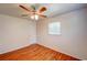 Bright bedroom featuring wood-look floors, neutral walls, ceiling fan, and window overlooking the outdoors at 14 Cyclops Dr, Apopka, FL 32703