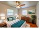 Cozy bedroom featuring a queen bed, two windows, and a stylish decor at 14 Cyclops Dr, Apopka, FL 32703