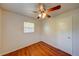 Small bedroom featuring wood-look floors, neutral walls, a ceiling fan, and a window at 14 Cyclops Dr, Apopka, FL 32703