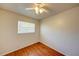 Compact bedroom featuring wood-look floors, a white ceiling fan, and a window at 14 Cyclops Dr, Apopka, FL 32703