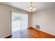 Bright dining area features hardwood floors and a sliding glass door that leads to the backyard at 14 Cyclops Dr, Apopka, FL 32703