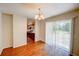 Open dining area with hardwood floors connects to the kitchen, offering a seamless flow and backyard access at 14 Cyclops Dr, Apopka, FL 32703