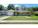 Charming single-story home with a well-manicured front yard and a driveway leading to a single-car garage at 14 Cyclops Dr, Apopka, FL 32703