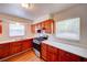 Charming kitchen features stainless steel appliances, granite countertops, and warm wood cabinets at 14 Cyclops Dr, Apopka, FL 32703