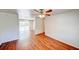 Spacious living room featuring wood floors, a ceiling fan, and access to the backyard at 14 Cyclops Dr, Apopka, FL 32703
