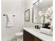 Stylish half bathroom with a modern vanity, decorative tile, black fixtures, and a decorative flower arrangement at 1401 Canberra Ave, Orlando, FL 32806