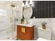Modern bathroom with a walk-in shower, marble tile, dark accent wall, and gold hardware at 1401 Canberra Ave, Orlando, FL 32806