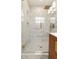Bright bathroom featuring a large glass shower with white and gray marble tiling and gold hardware at 1401 Canberra Ave, Orlando, FL 32806