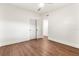 Minimalist bedroom with wood laminate flooring, a ceiling fan, and closet, with white walls and trim at 1401 Canberra Ave, Orlando, FL 32806