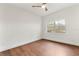 Bright bedroom featuring a window providing natural light, wood laminate flooring, and modern ceiling fan at 1401 Canberra Ave, Orlando, FL 32806