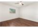 Cozy bedroom features ceiling fan, wood flooring, and a bright window at 1401 Canberra Ave, Orlando, FL 32806
