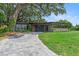Single Gathering home boasts modern exterior, driveway and mature landscaping at 1401 Canberra Ave, Orlando, FL 32806