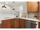The corner of the kitchen is full of light and features modern finishes and wood cabinetry at 1401 Canberra Ave, Orlando, FL 32806