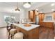 Open kitchen with quartz countertops, wooden cabinets, stainless steel appliances, and adjacent dining area at 1401 Canberra Ave, Orlando, FL 32806