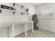 Well-lit laundry room with decorative tile, storage, and energy-efficient water heater at 1401 Canberra Ave, Orlando, FL 32806