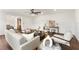 Bright and spacious living room featuring a sofa, accent chairs, a dark table, and wood laminate floors at 1401 Canberra Ave, Orlando, FL 32806