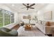 Cozy living room showcases a large window, comfortable seating and a stylish rug at 1401 Canberra Ave, Orlando, FL 32806
