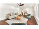 Bright living room featuring hardwood floors, a ceiling fan and neutral-colored furniture at 1401 Canberra Ave, Orlando, FL 32806