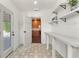 Entryway features decorative tile, storage shelves, and a view of the adjacent kitchen at 1401 Canberra Ave, Orlando, FL 32806
