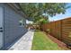 A long side yard offers new pavers, privacy fence and fresh landscaping at 1401 Canberra Ave, Orlando, FL 32806