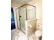 Bathroom with tiled shower, toilet, and patterned floor tiles at 1513 Maidstone Ct, Davenport, FL 33896