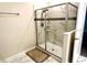 Bathroom with a modern shower featuring marble-like tile and glass door at 1513 Maidstone Ct, Davenport, FL 33896