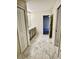 A contemporary bathroom boasts double sinks, gray cabinets, and patterned tile flooring at 1513 Maidstone Ct, Davenport, FL 33896