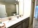Bathroom with double sinks, light countertops, and modern fixtures at 1513 Maidstone Ct, Davenport, FL 33896