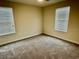 Well lit bedroom with two windows and neutral walls at 1513 Maidstone Ct, Davenport, FL 33896
