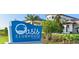Welcoming sign for Oasis Clubhouse at ChampionsGate with tropical landscaping at 1513 Maidstone Ct, Davenport, FL 33896
