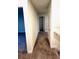 Upstairs hallway features neutral walls and carpet with access to multiple rooms at 1513 Maidstone Ct, Davenport, FL 33896