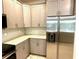 Modern kitchen featuring stainless steel refrigerator and grey cabinets at 1513 Maidstone Ct, Davenport, FL 33896