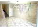 Bright living room features designer accent wall, modern light fixture, and ceramic tile flooring at 1513 Maidstone Ct, Davenport, FL 33896