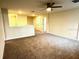 Spacious living room with neutral carpet and ceiling fan at 1513 Maidstone Ct, Davenport, FL 33896