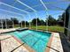 Inviting screened-in pool and spa offers a relaxing outdoor space with clear blue water at 1513 Maidstone Ct, Davenport, FL 33896